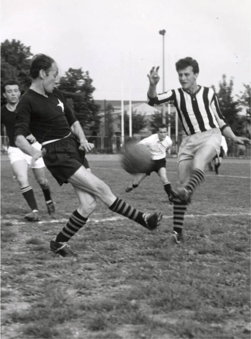 Two players compete for the ball during a football match